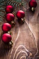 group of red christmas baubles and branch fir tree on photo