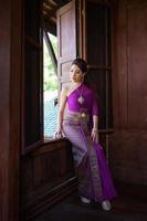 Younf woman wearing typical Thai dress photo