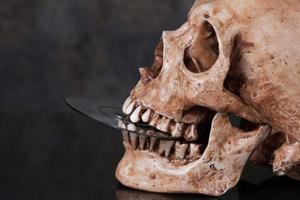 Human skull and dvd in mouth
