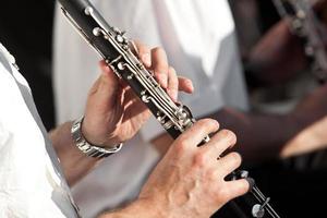 Human hands playing a clarinet