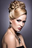 Beautiful girl with bright makeup and evening hairstyle. photo