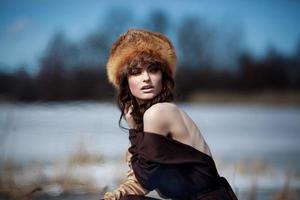 portrait of a beautiful smiling girl in a fur hat