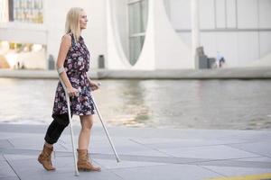 blonde woman with crutches
