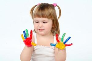 little girl bedaubed with bright colors photo