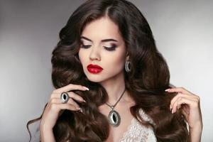 Hair. Beautiful model with elegant wavy long hairstyle. Beauty
