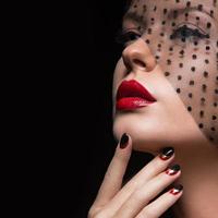 Beautiful girl with a veil, evening makeup, black and red