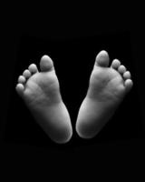 Black and white photograph of new born baby feet photo