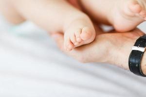 Baby foot in father's hand