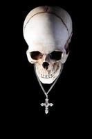 Human skull with silver cross