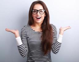 Beautiful excited woman in glasses with natural surprising emoti photo