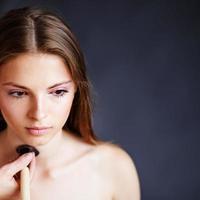 girl applying make-up by make-up artist.