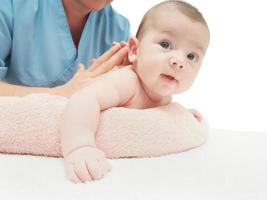 Doctor massage small caucasian baby