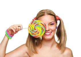 Girl eating colourful lollipop. Lollipop. photo
