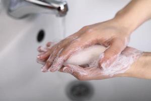 Hygiene concept of someone washing their hands with soap photo