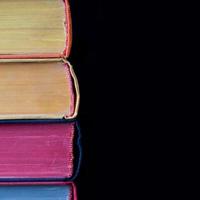 Colorful books. hard cover. Black background. Isolated photo
