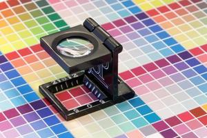 Close-up of a loupe on a colorful test print photo