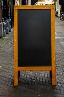Empty Chalkboard on City Street photo