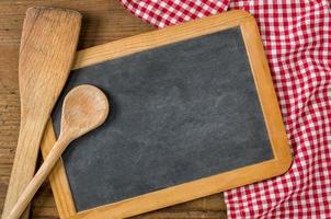 Chalkboard with wooden spoons on a red checkered tablecloth photo