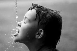 Drops of water splashed on boy's face photo