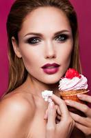 Beautiful fashion girl with cupcake photo