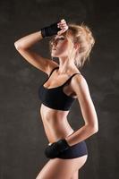 Beautiful fit woman model in black hand bandage photo