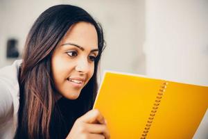 Happy Indian woman student education writing studying photo