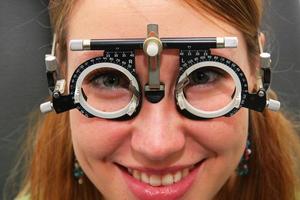 Young girl at the optometrist checking her vision photo