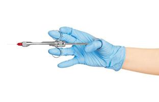 Hand in blue glove holding dental tool isolated on white