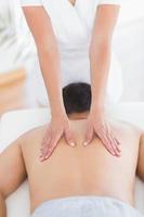 Physiotherapist doing back massage to her patient photo