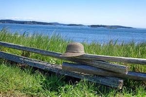 Split Rail Fence with Hat on water front photo