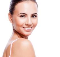 Beautiful face of young adult woman with clean fresh skin photo