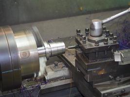 operator turning mold parts by manual lathe photo