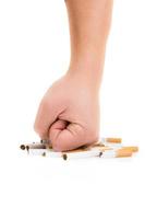 Man's fist crushing cigarettes isolated on white background