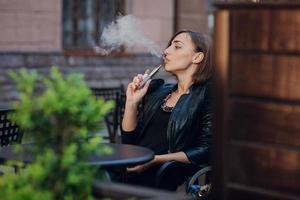 beautiful glamorous brunette smoke electronic cigarette photo