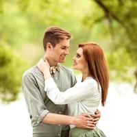 couple in love in park smiling holding a bouquet photo