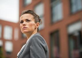 serious business woman in front of office building photo