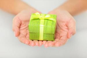 Colourful green gift in cupped hands