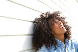 Beautiful young woman laughing outdoors photo