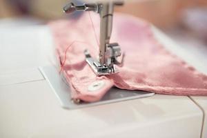 closeup on seamstress sewing machine photo