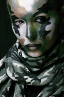 woman with military style clothing and face paint make-up photo