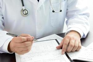Doctor writing medical certificate
