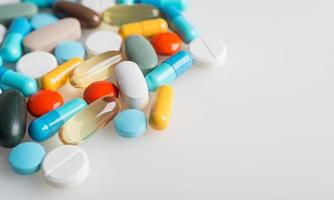 Composition with colourful pills and light grey background.