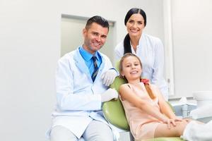 equipo de dentistas y paciente feliz en la clínica dental