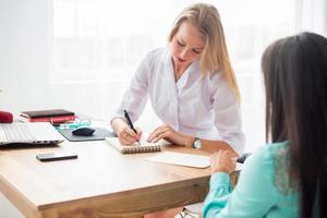 Medical physician doctor woman writing prescription taking notes in office