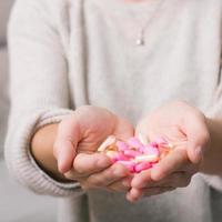 Close-up shot of a hand holding pills.