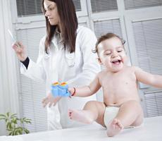 Pediatrician preparing injection for a baby photo
