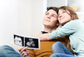 Cute couple imagines the future of their unborn child photo