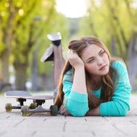 Teenage girl with skateboard photo