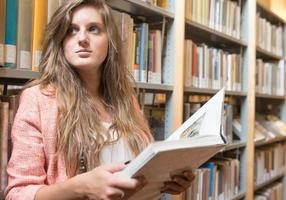 Portrait of a pretty girl inside a library photo