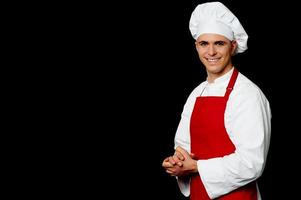 Isolated male chef over black background